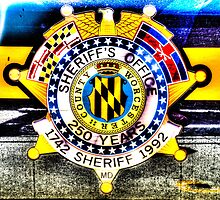 Sheriff Badge on a Police Car in Assateague, Maryland, USA by Noam Kostucki