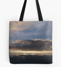 Sunset behind clouds with rays Tote Bag