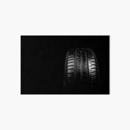 Car tyre isolated on a black background Art Board Print