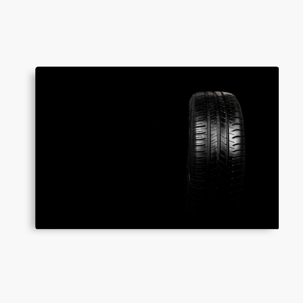 Car tyre isolated on a black background Canvas Print
