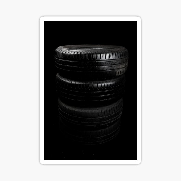 Close up view of car tyres isolated on a black background Sticker