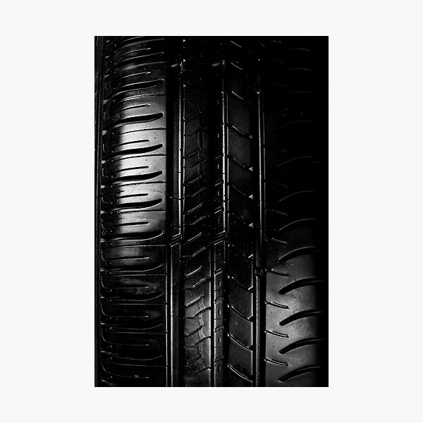 Close up view of car tyre isolated on a black background Photographic Print