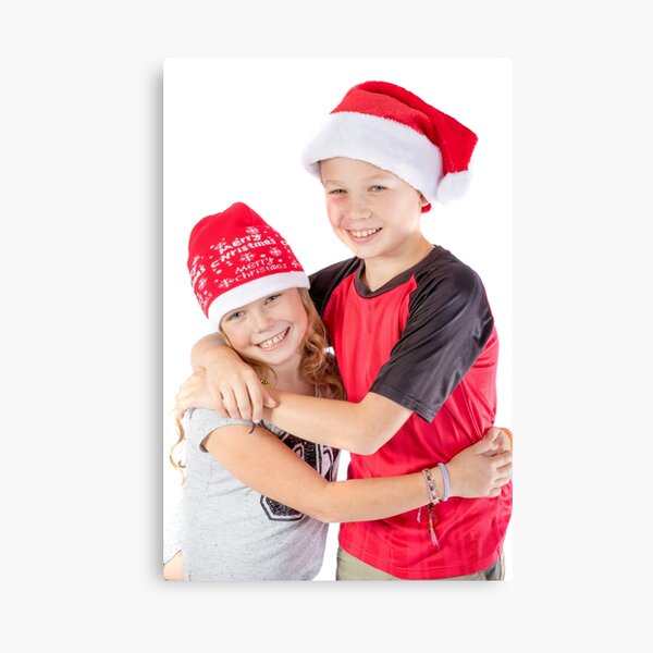 Siblings embracing for christmas Canvas Print