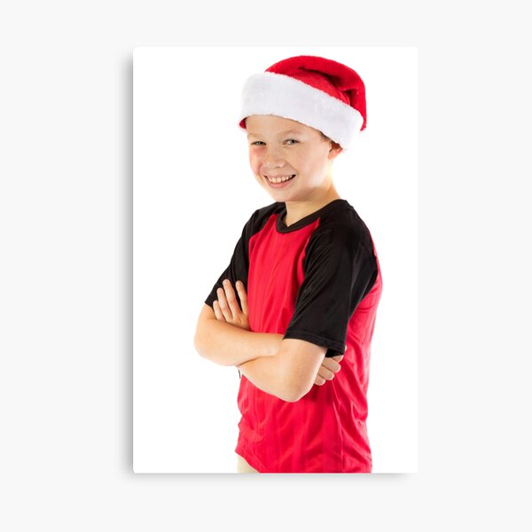 Pre-teen boy wearing a christmas hat Canvas Print