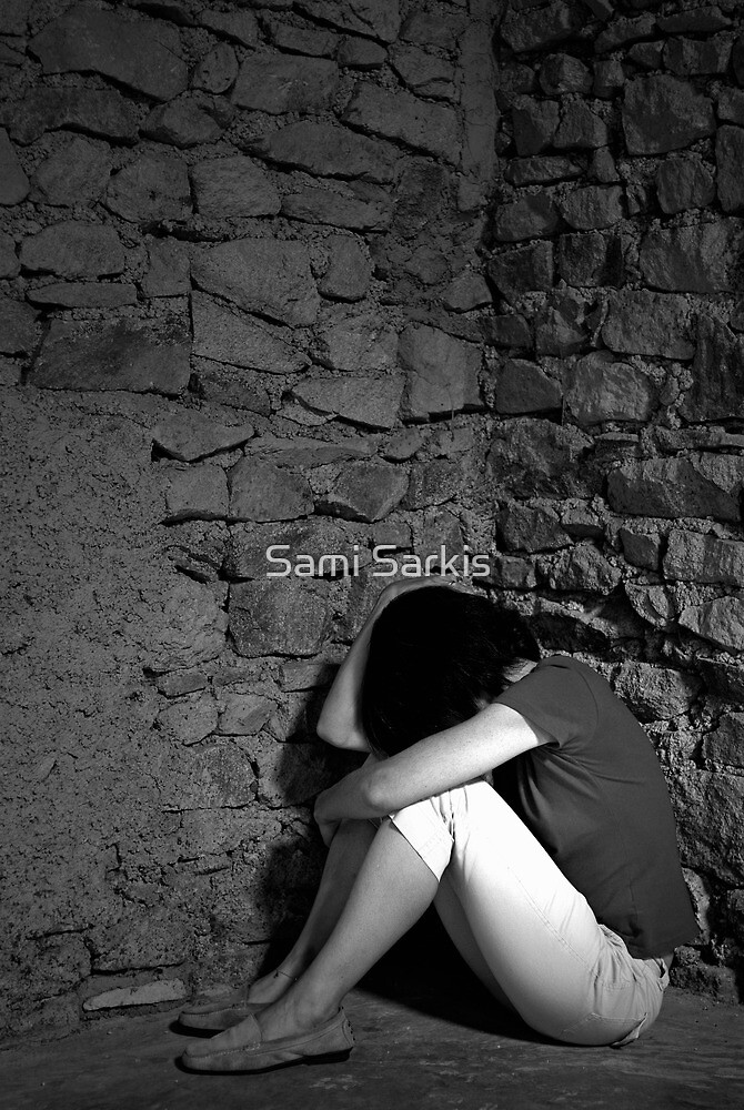 "Depressed woman sitting with head in hands in a room corner " by Sami