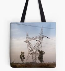 A large steel based electric pylon carrying high tension power lines Tote Bag