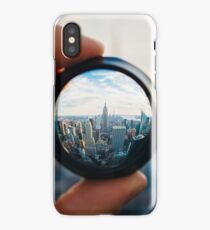 Man holding a lens over Manhattan iPhone Case