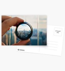 Man holding a lens over Manhattan Postcards