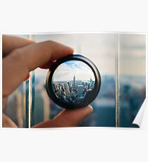 Man holding a lens over Manhattan Poster