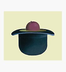 A single plum floating in perfume served in a man's hat Photographic Print