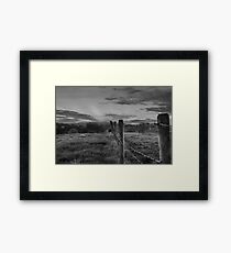 Barbed wire, angry sky. Framed Print