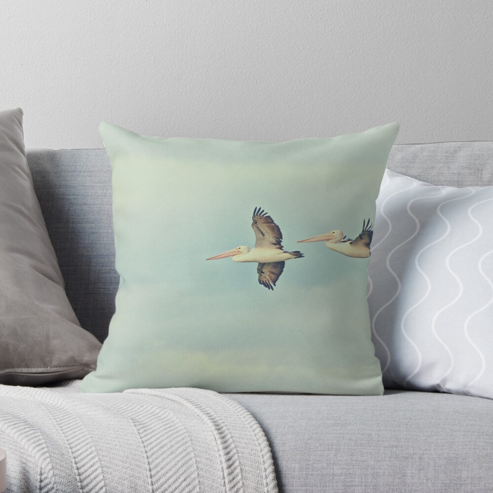 Pelicans in flight Throw Pillow