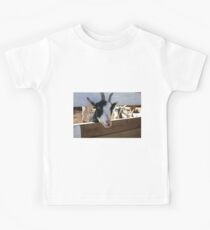 Goat looking through fence for food Kids Tee