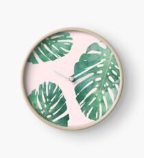 Watercolor tropical monstera leaves on pink background Clock