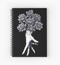 Hand with lotuses on black Spiral Notebook