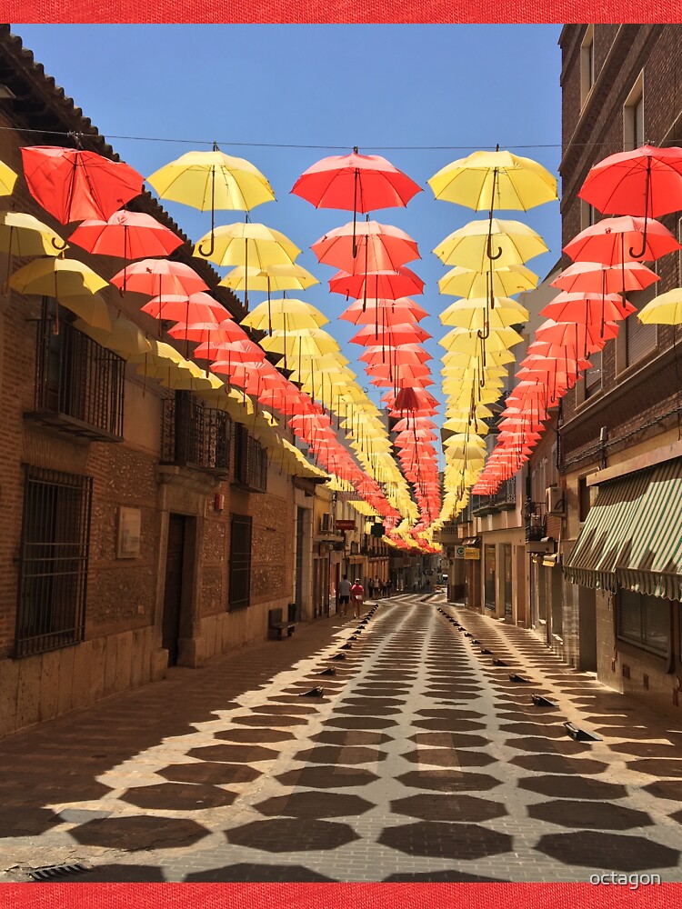 "Street of Yellow and Red Hanging Umbrellas in Valdepeñas, Spain" T