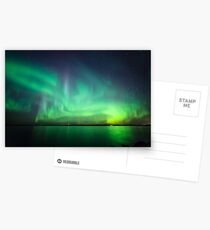 Northern lights over lake Postcards