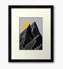 The dark peaks under the golden sun Framed Print