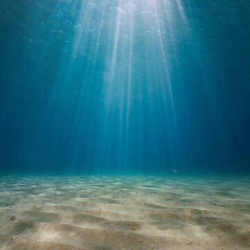 Rays of sunlight underwater with sandy seabed Mediterranean sea