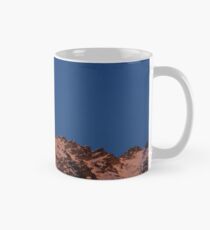 Moon coming up from bedind mountains Mug