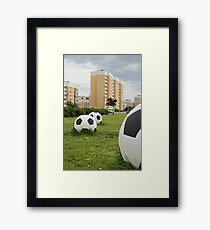 soccer balls on the cityscape Framed Print