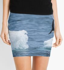 Adelie penguin jumping between two ice floes Mini Skirt