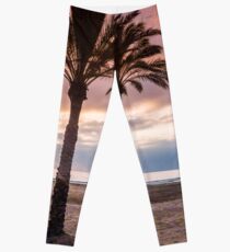 The Sun Rising Between Three Palm Trees on The Beach Leggings