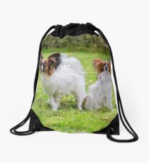 Outdoor portrait of a papillon purebreed dogs on the grass Drawstring Bag