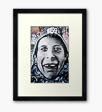 Graffiti Face of teethless boy Framed Print
