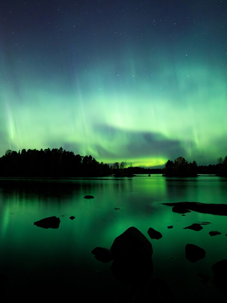 Beautiful northern lights over lake by Juhku