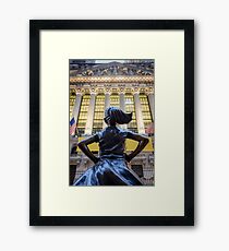 Fearless Girl statue facing the NYSE building Framed Print