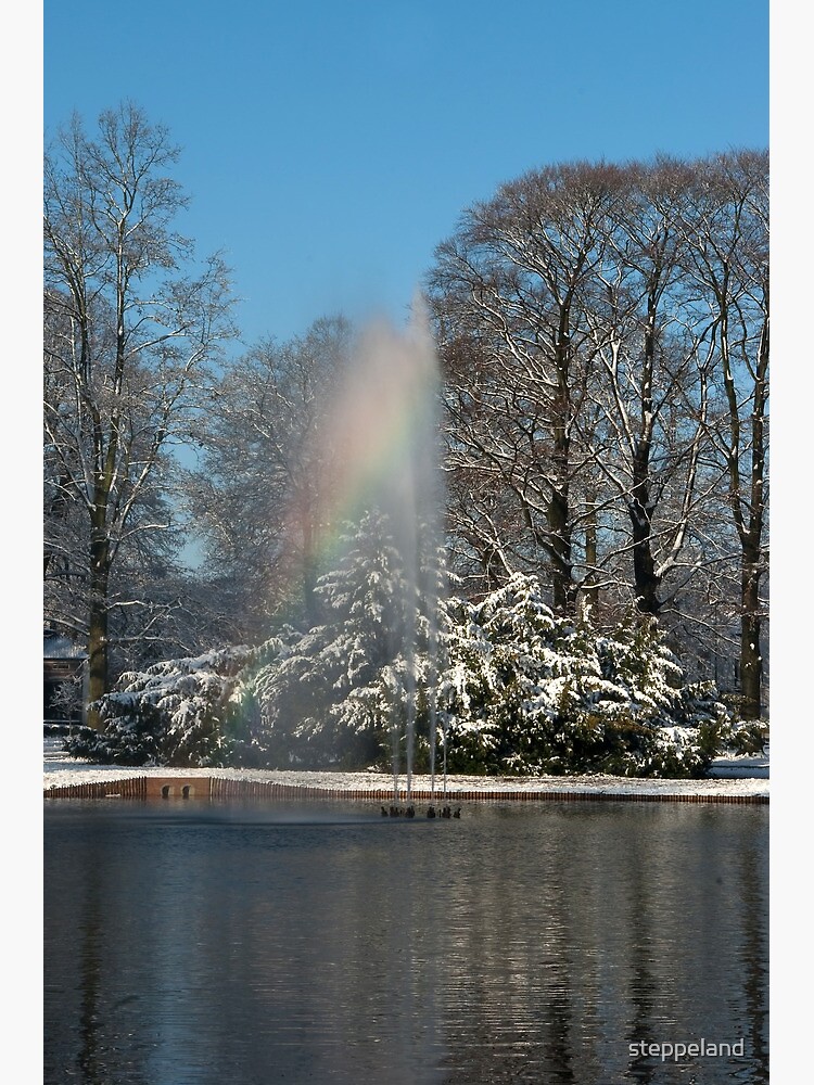 Rainbow fountain in snowy park by steppeland
