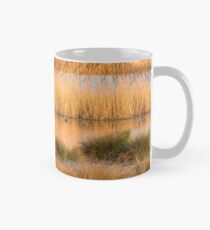 The warm evening sun hits reed beds at Wicken Fen Nature Reserve Classic Mug