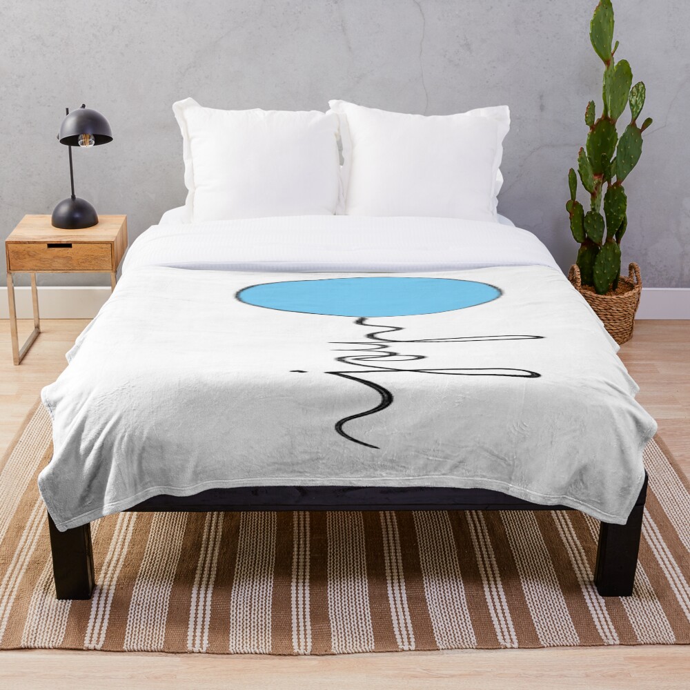Joy Balloon on a throw blanket