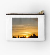 Golden sunset streaked by jet streams Studio Pouch
