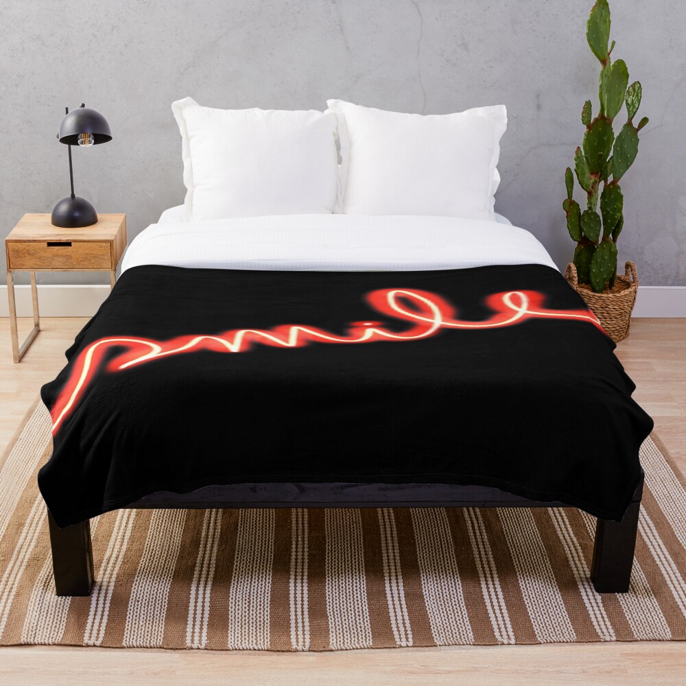 Smile Red Neon Sign on a throw blanket