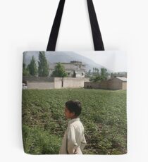 Pakistan- An Afghan boy view the house of former al-Qaida leader Osama bin Laden Tote Bag